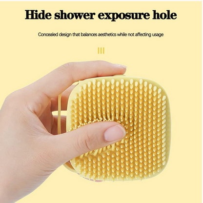 A hand holds the yellow silicone bath brush, showing its soft bristles and a concealed shower exposure hole.