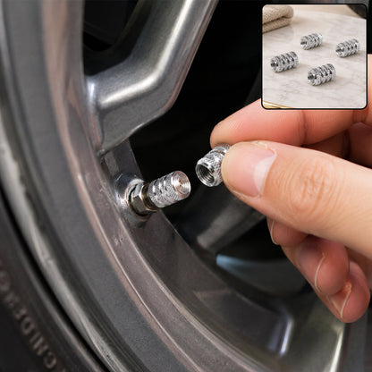 A hand screwing a silver textured valve cap onto a car tire valve stem; inset shows four caps.