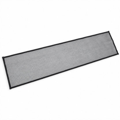 A rectangular piece of black mesh safety net with black fabric edges lies flat on a white surface.
