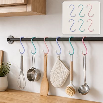 Six colorful plastic coated S hooks hanging kitchen utensils on a black rod in a modern kitchen.
