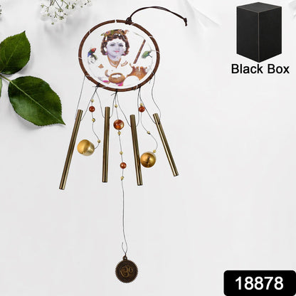 A Krishna wind chime with a black box and the number 18878 in the bottom right corner, hanging against a white wall.