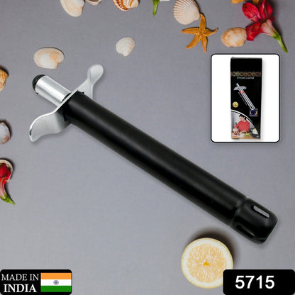 A black and silver gas lighter lies on a gray surface with seashells and a lemon slice, next to its packaging.