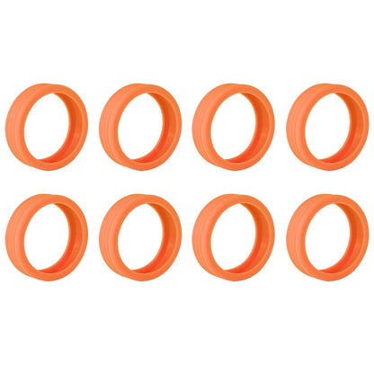 Eight orange silicone wheel covers with a ribbed texture, arranged in two rows on a white background.