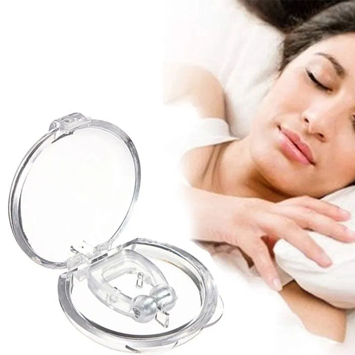 A clear anti-snoring nose clip in an open round plastic case, with a woman sleeping peacefully in the background.