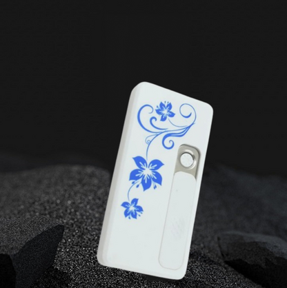 White USB lighter with blue floral pattern stands upright on a textured dark surface.
