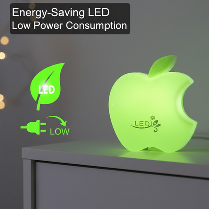 Green apple-shaped LED night light glowing on a white dresser, with text about energy saving.