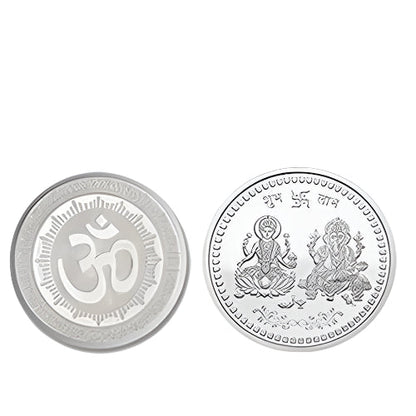 Two silver coins, one with an Om symbol and the other with Lakshmi and Ganesha, on a white background.