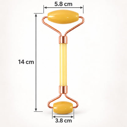 A yellow jade facial roller with rose gold frame is displayed with its dimensions of 14 cm length and roller widths of 5.8