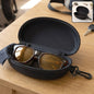 An open black hard shell sunglasses case with brown sunglasses and a black cleaning cloth inside, on a wooden table.