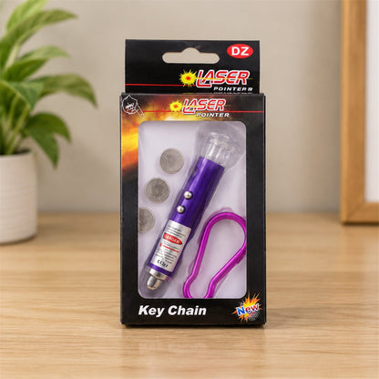The purple laser pointer keychain, batteries, and clip are packaged in a black box with a clear window.