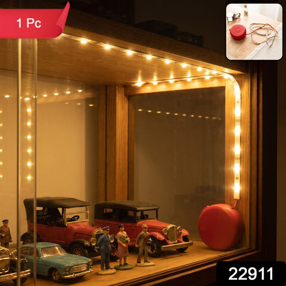 A close-up of the LED strip lights installed in a display cabinet, highlighting the warm glow.