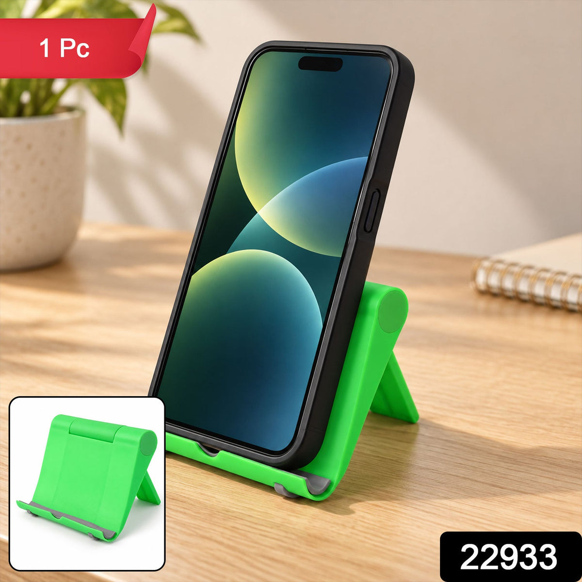 A black smartphone is propped on a green stand, with a small inset showing the stand folded.