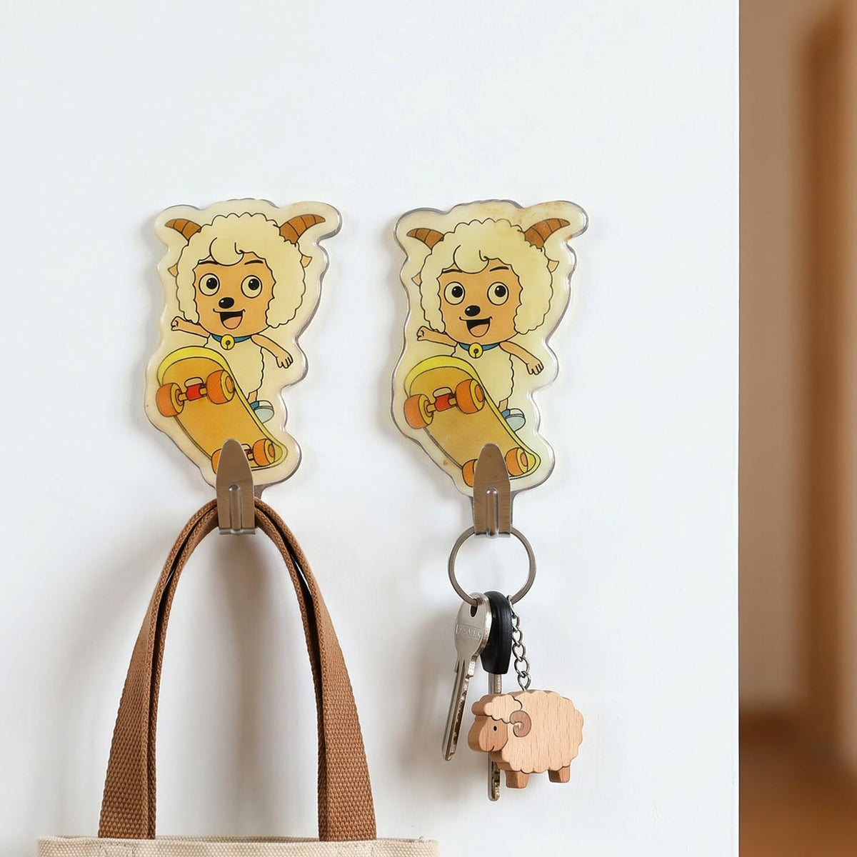 Two cartoon sheep on skateboards, acting as wall hooks, with a brown bag and keys hanging from them.