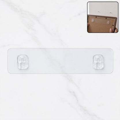 A clear adhesive wall hook strip with two hooks on a white marble background, with an inset showing it applied to a picture