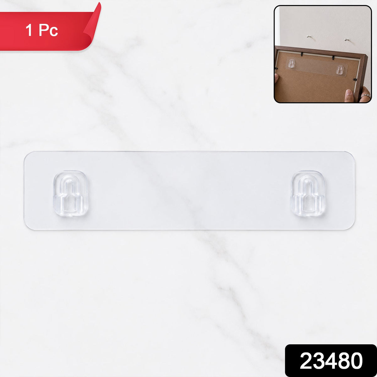 A clear adhesive wall hook strip with two hooks on a white marble background, with a small inset image showing it applied to