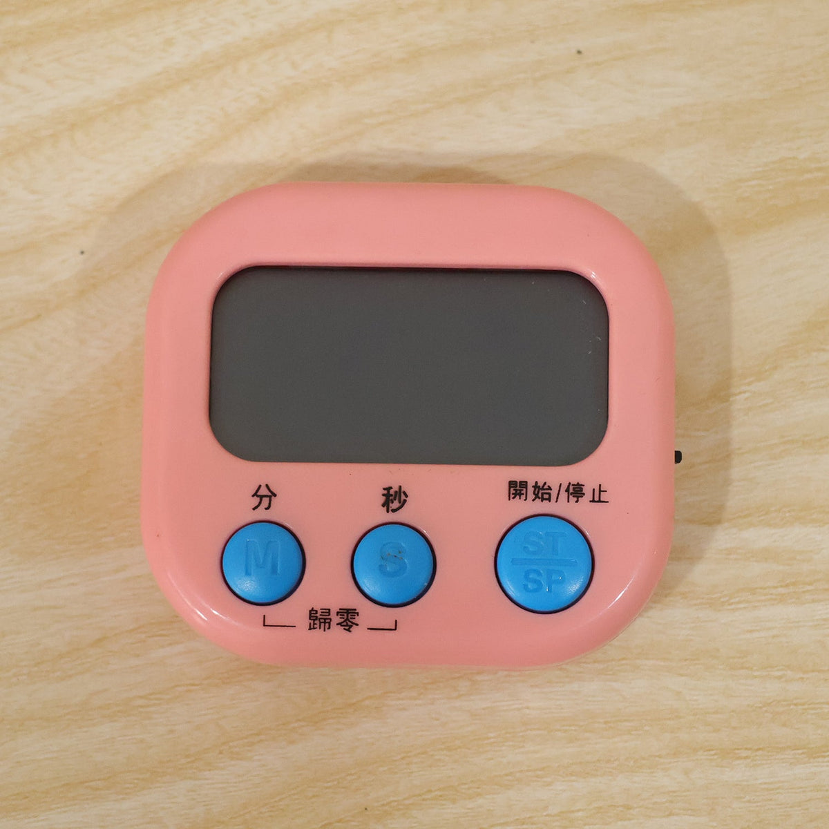 Digital kitchen timer in use during a cooking task with ingredients
