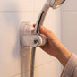 Suction cup shower head holder installed on bathroom wall