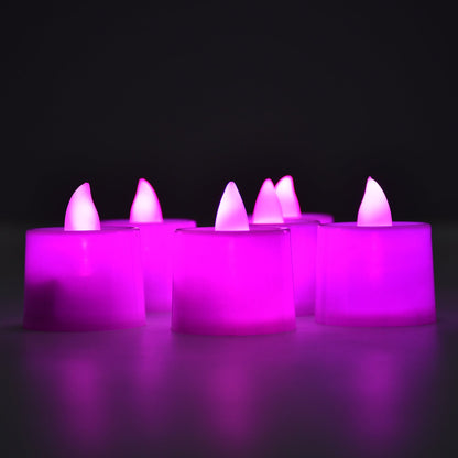 Six pink LED flameless tealights glowing brightly in a dark setting.