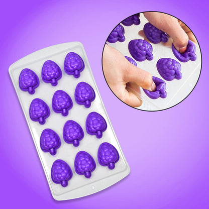 Close-up of hands pressing on the bottom of the purple silicone fruit molds to release ice cubes.