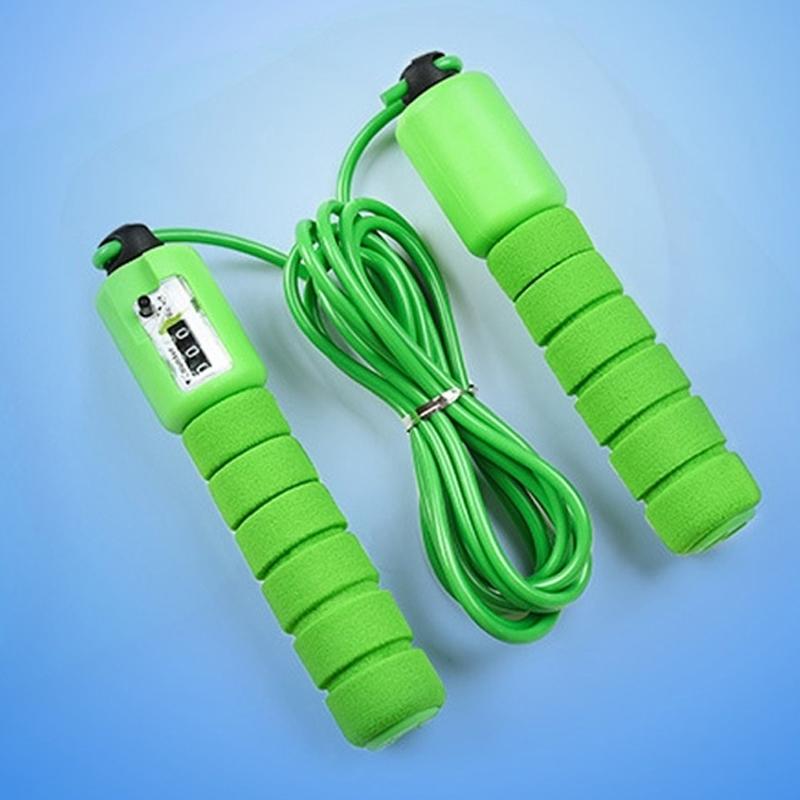 A green electronic counting skipping rope with foam handles and a digital display is presented on a light blue background.