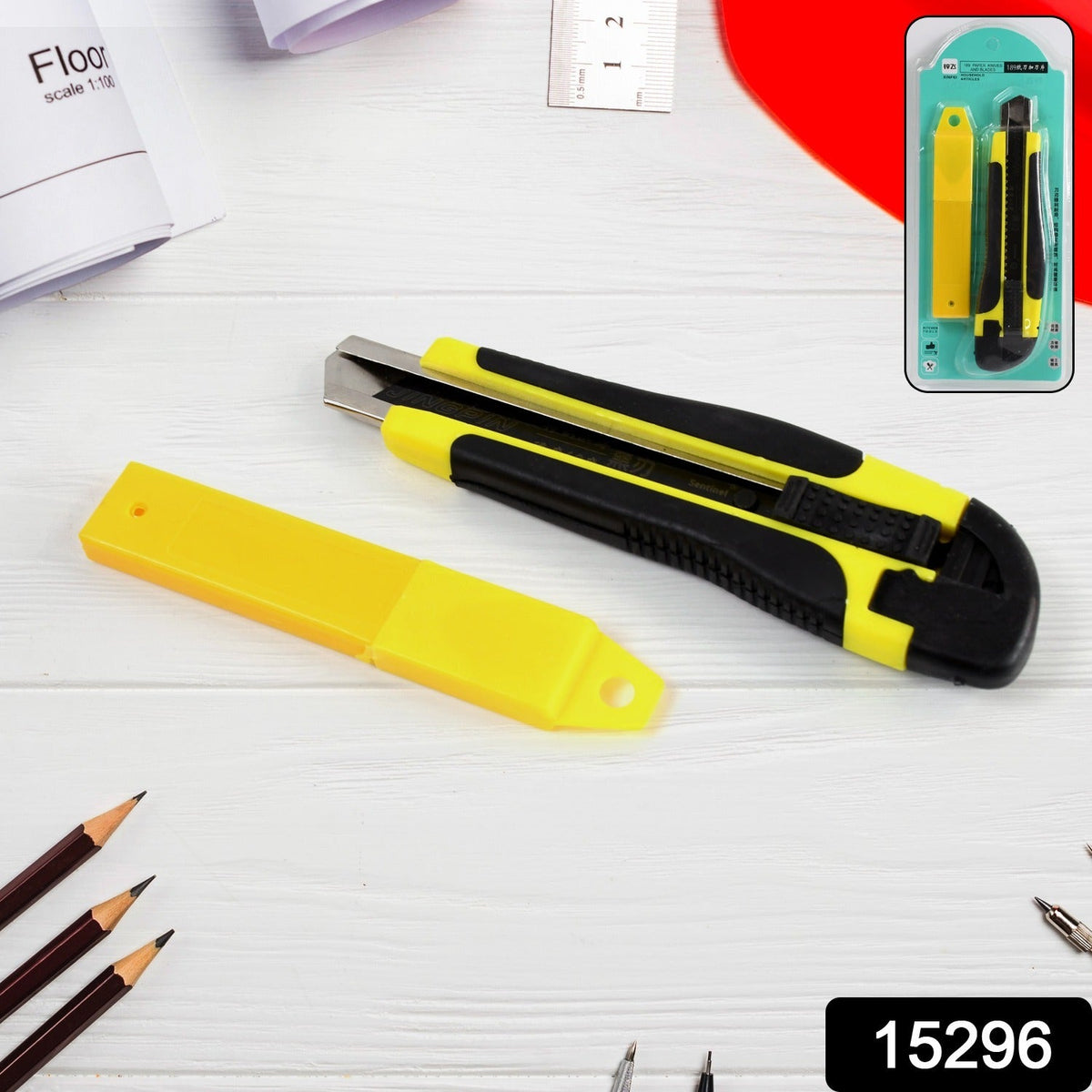 A yellow and black utility knife with a yellow blade cover, next to its retail packaging.
