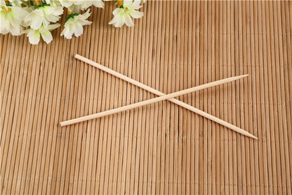 Bundle of natural bamboo skewers tied with string for display.