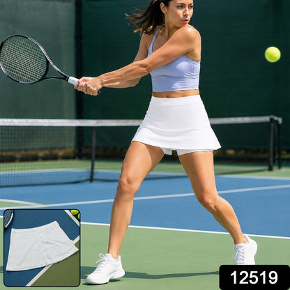 A woman in a white skort and lavender top plays tennis on a blue court, with a small inset of the white skort.