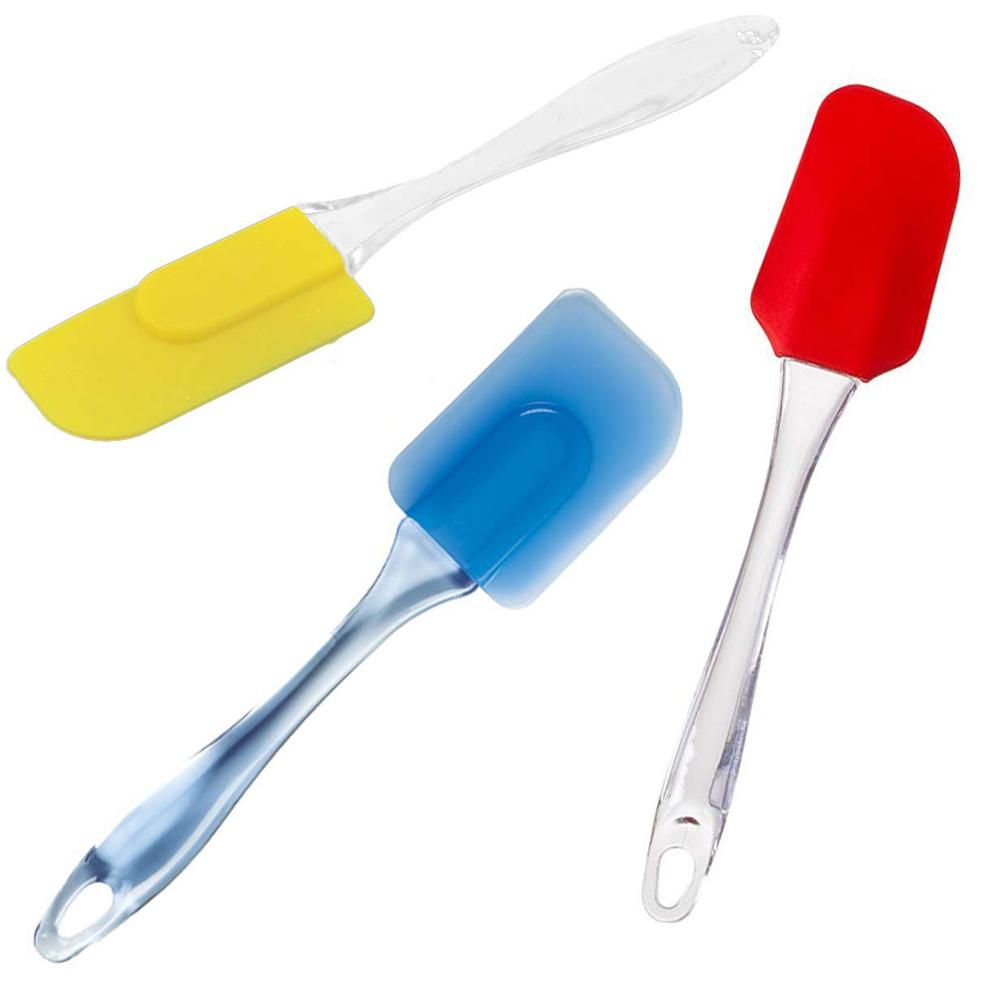 Three silicone spatulas with clear handles are shown: one yellow, one blue, and one red.