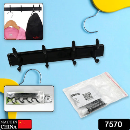 Black four-hook coat rack with insets showing it holding a pink shirt and black bag, plus packaging and adhesive.