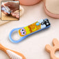 A light blue baby nail clipper with a yellow and white owl design, shown with an inset of it being used.