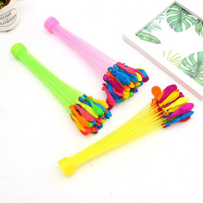 Three bunches of colorful water balloons with green, pink, and yellow nozzles on a white surface.