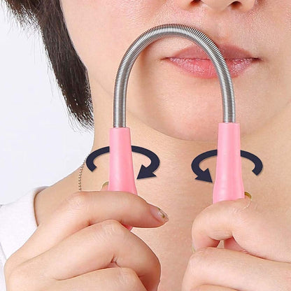 A person's chin and mouth with the pink and silver facial hair remover spring tool in use, showing rotating arrows.