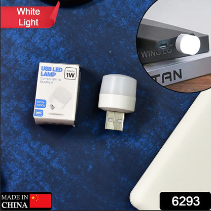 A white USB LED lamp and its small white packaging are displayed on a blue textured surface.