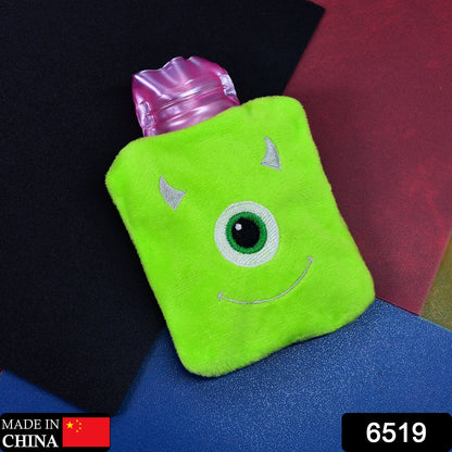 A green monster hot water bag with a pink top sits on a dark background with a "Made in China" label.
