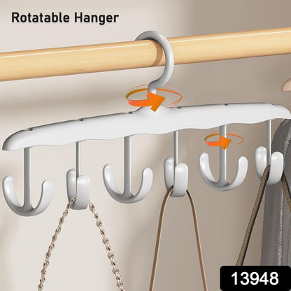 White plastic hanger with six rotating hooks, holding two bags on a wooden closet rod, with text overlay.
