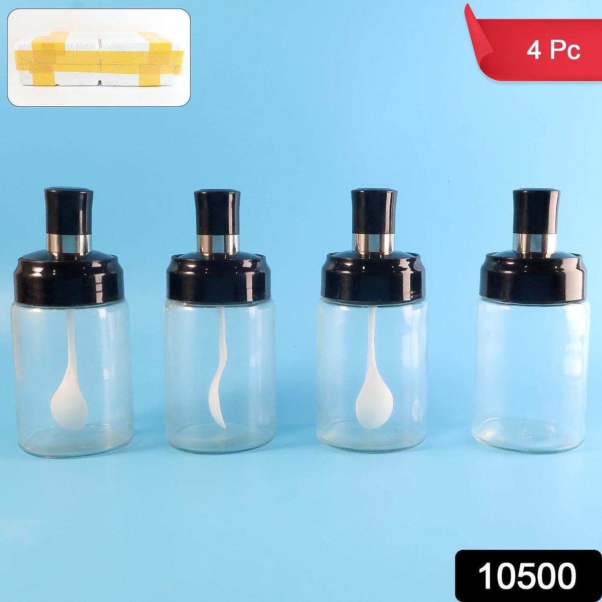 Four transparent spice jars with black lids and white spoons on a blue background.