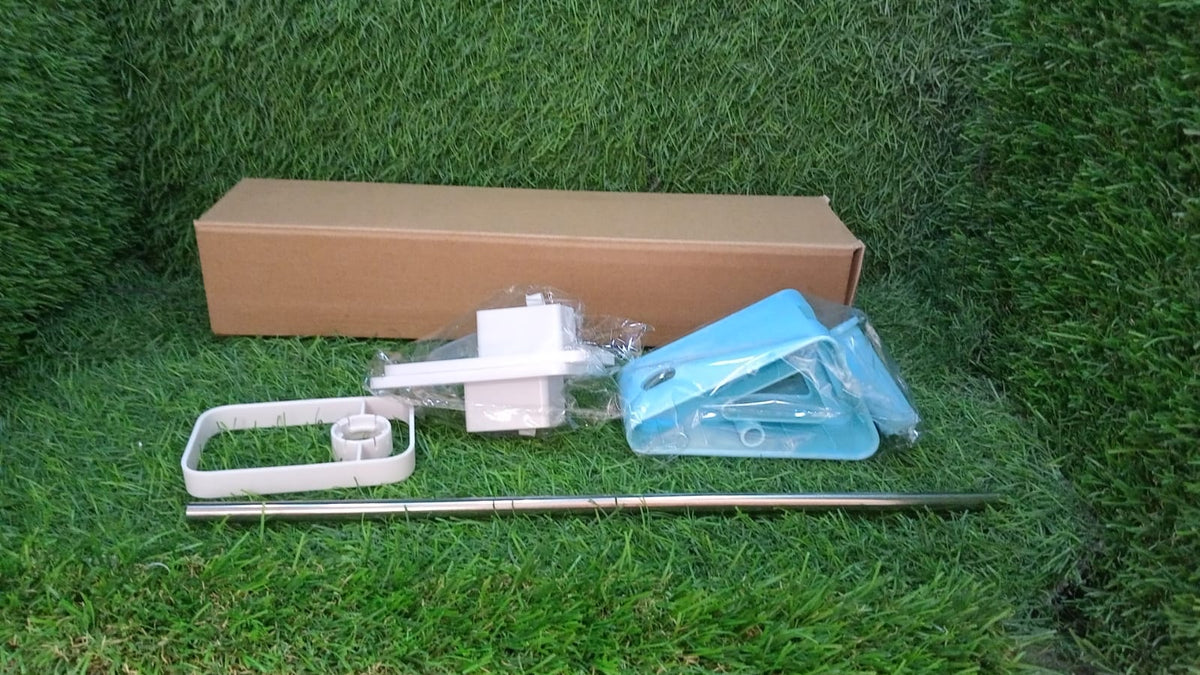 Disassembled components of the drying rack and a brown box laid out on green grass.