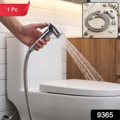 A hand holds a chrome bidet sprayer, spraying water towards a white toilet in a tiled bathroom, with a red "1 Pc" label.