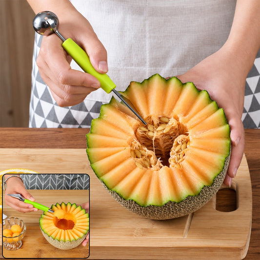 A person uses a green-handled dual-ended tool to scoop seeds from a carved cantaloupe melon on a wooden cutting board.