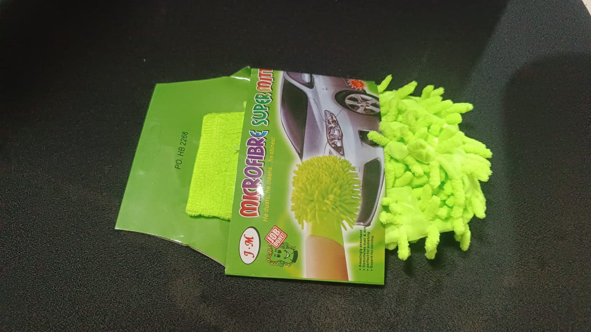 A bright green microfiber car wash glove and its green packaging with a car image on a dark surface.