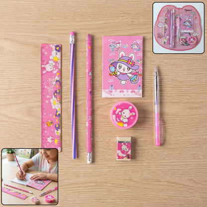 A pink 7-in-1 stationery set with bunny designs, including a ruler, pencils, notebook, sharpener, and eraser.