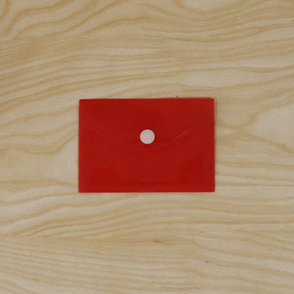 Hand holding a plastic document folder envelope, showing its transparency.