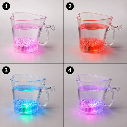Four clear heart-shaped mugs, each filled with water and glowing in different colors: pink, red, blue, and purple.