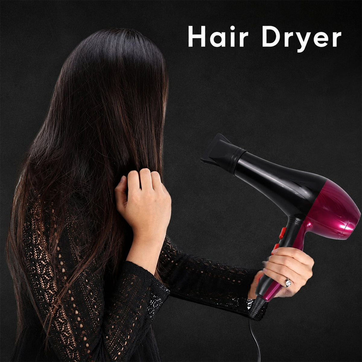 A woman from behind holds a red and black hair dryer to her long, dark hair against a black background.