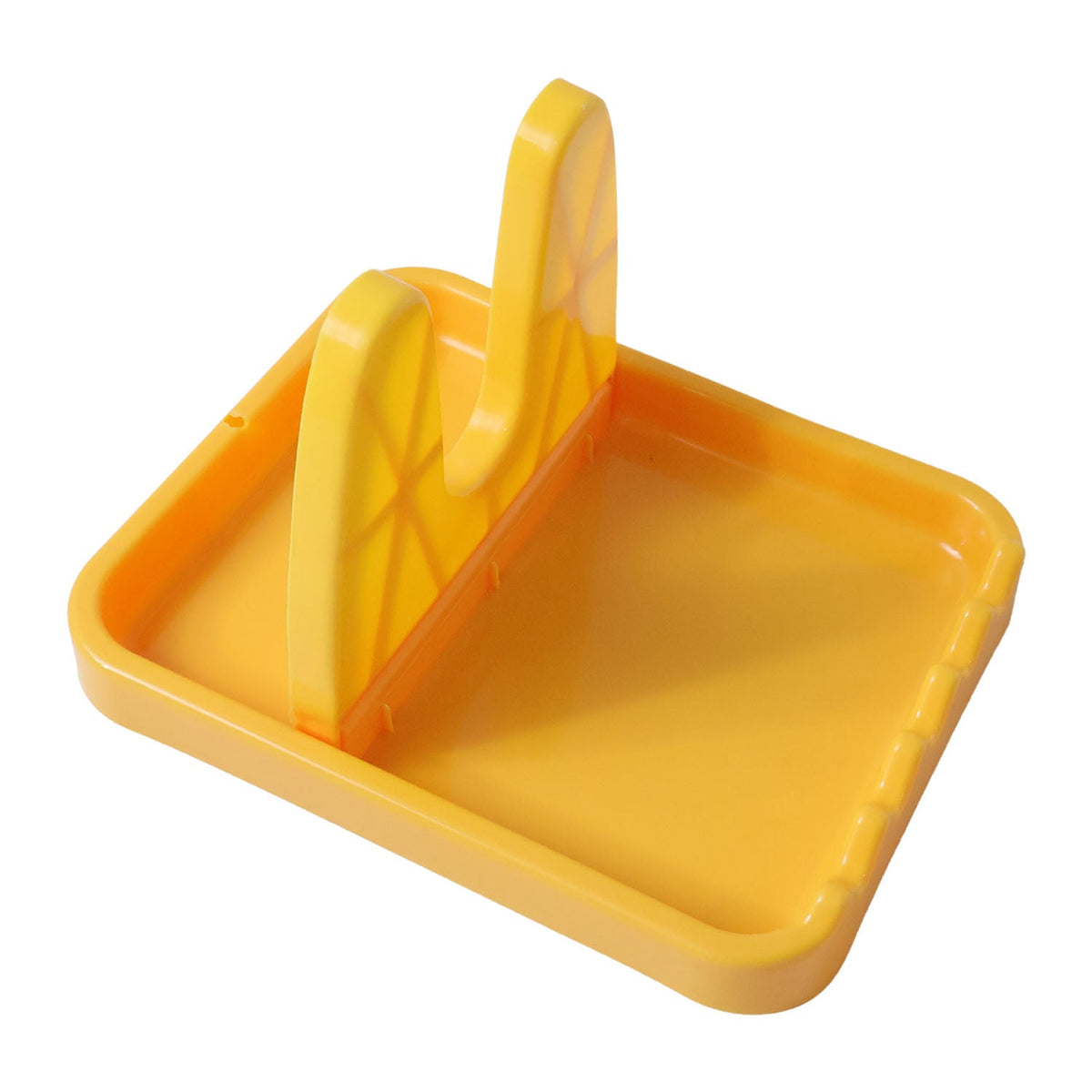 An empty yellow plastic lid and spoon rest with a textured base, viewed from an angle on a white background.