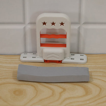 The white and orange mini mop is disassembled on a light wooden surface, with the gray sponge separate.