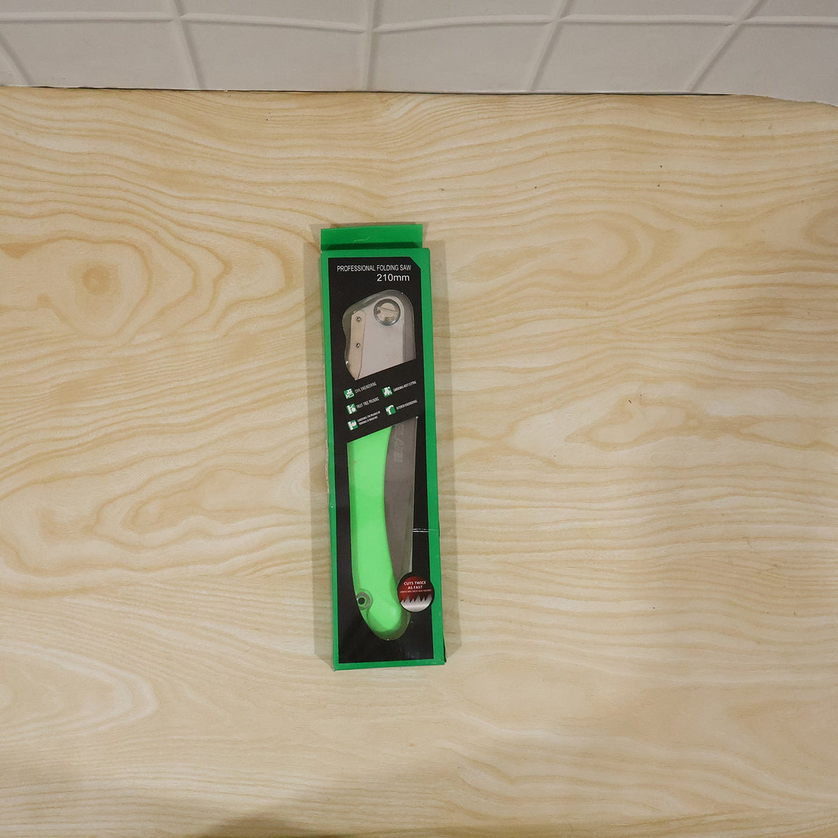 Green handle folding pruning saw ready for daily outdoor use