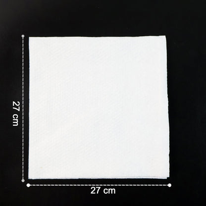 A single white paper napkin on a black surface, showing its 27 cm by 27 cm dimensions.