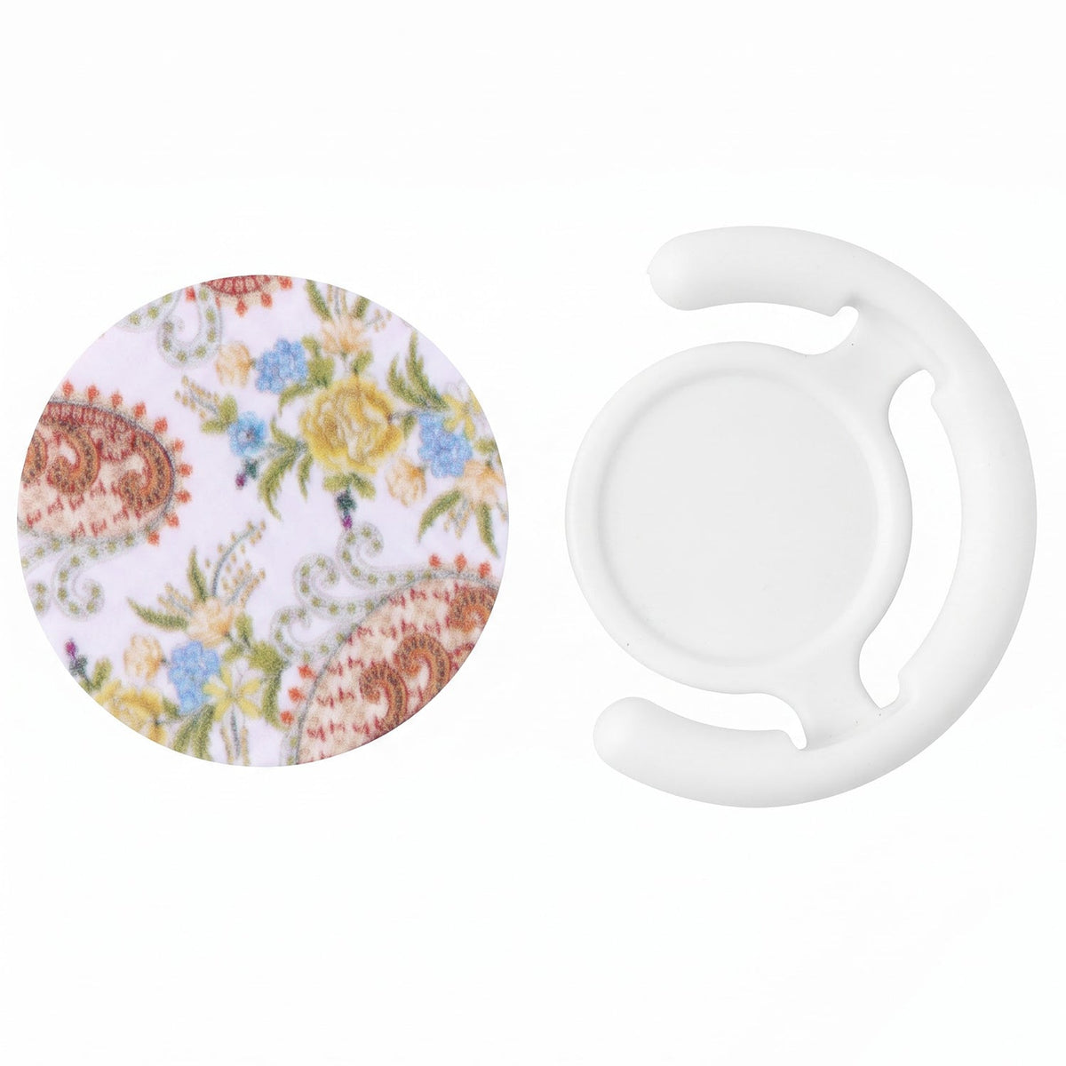A round pop socket with a white background and colorful paisley floral pattern next to a white plastic car vent mount on a