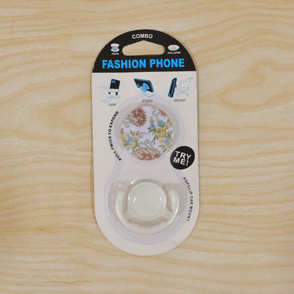 The versatile mobile phone holder with its enamel watermelon design, functioning as a kickstand on a flat surface.